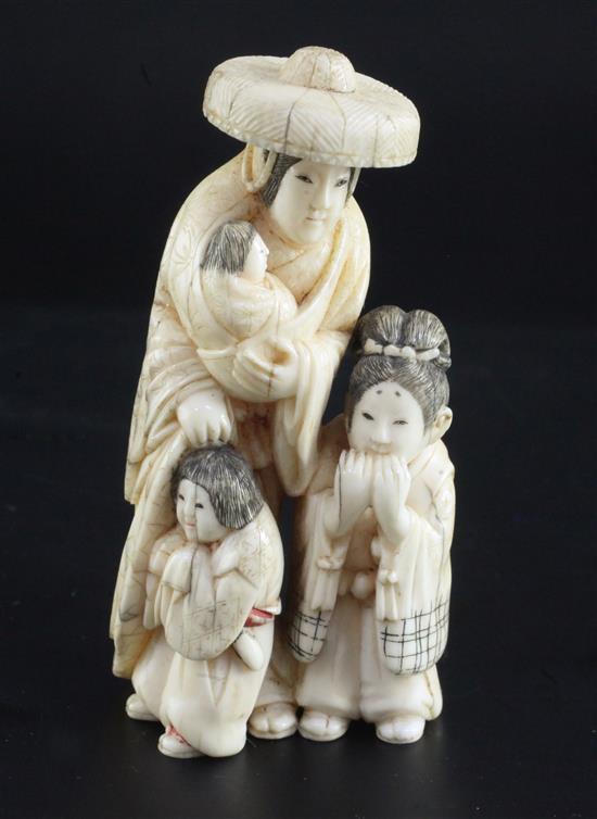 A Japanese walrus ivory okimono of a woman and three children, height 8.3cm